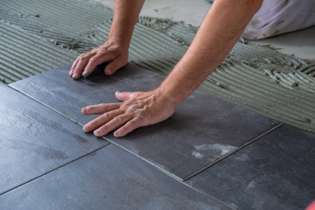 Gresham Worker installing ceramic floor tiles